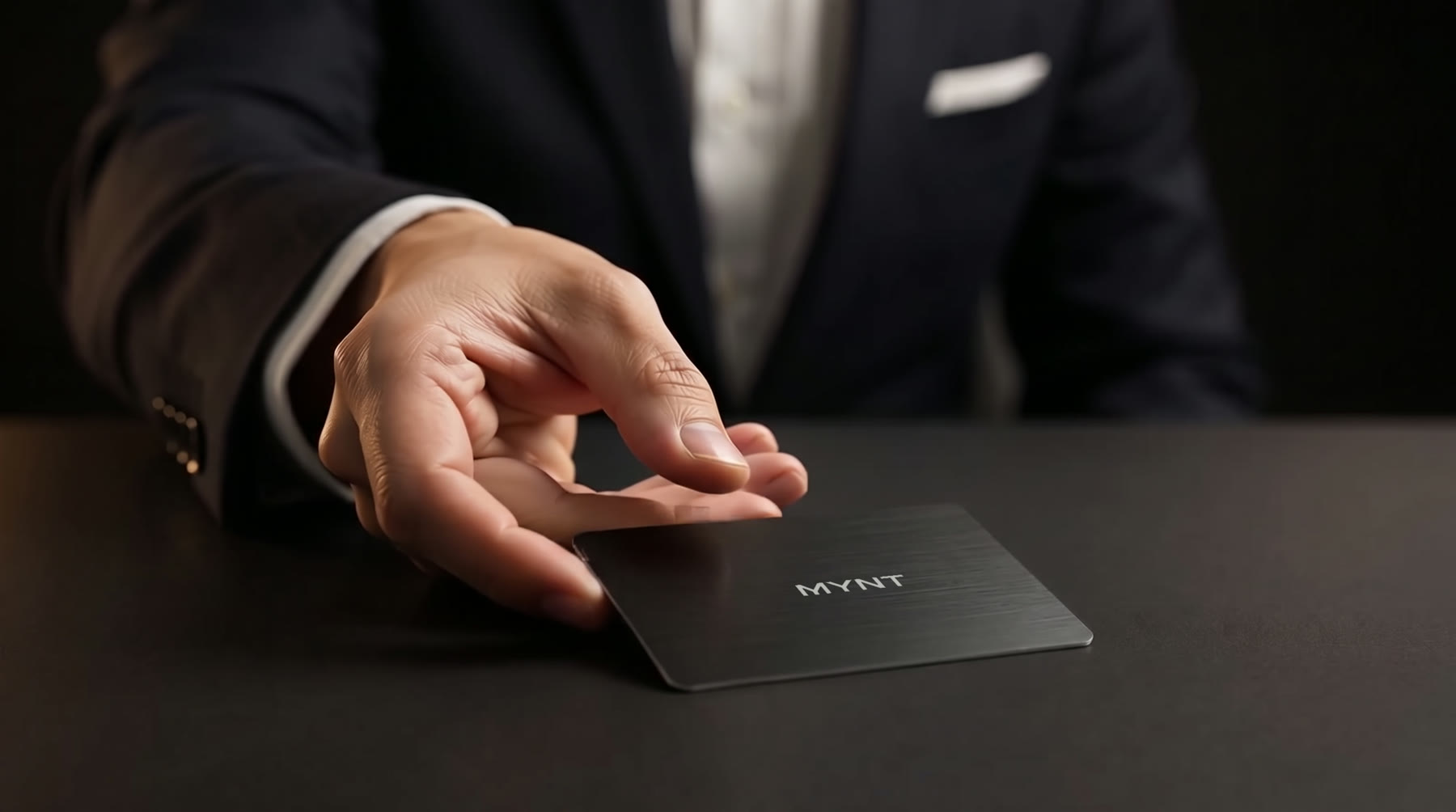 A black MYNT metal card placed on a table